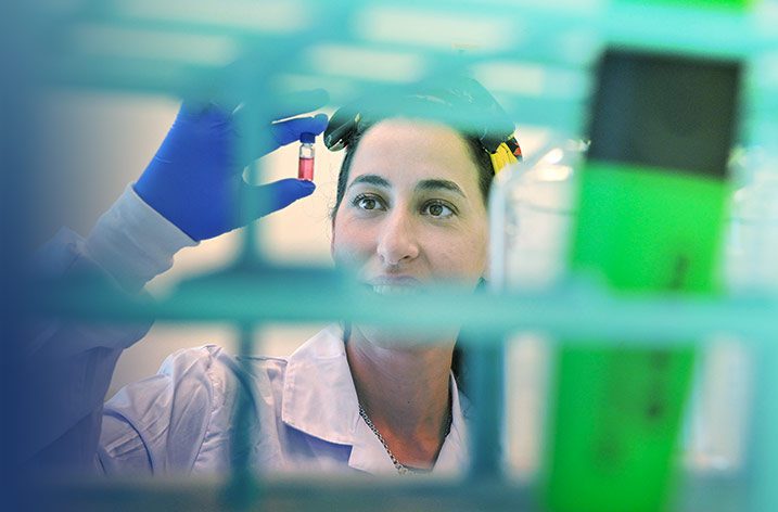employee looking at vial